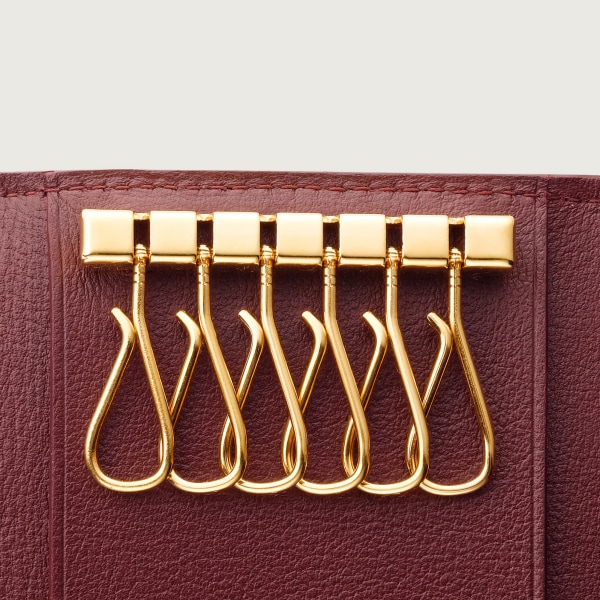 Must de Cartier 鑰匙圈，可掛6副鎖匙 酒紅色小牛皮，金色飾面