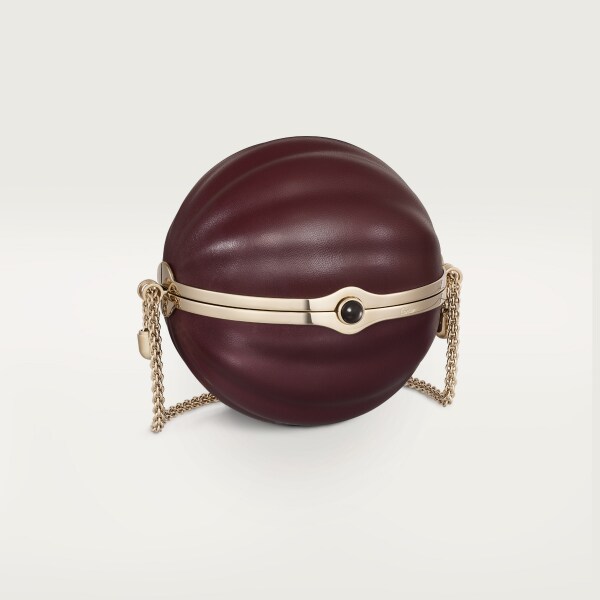 Round bag with gadroon motif, Cartier Soir Burgundy lambskin, hessonite garnet and golden finish